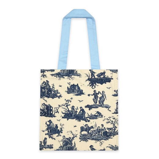 The back of a tote bag featuring a blue pattern with pastoral scenes on a white background.