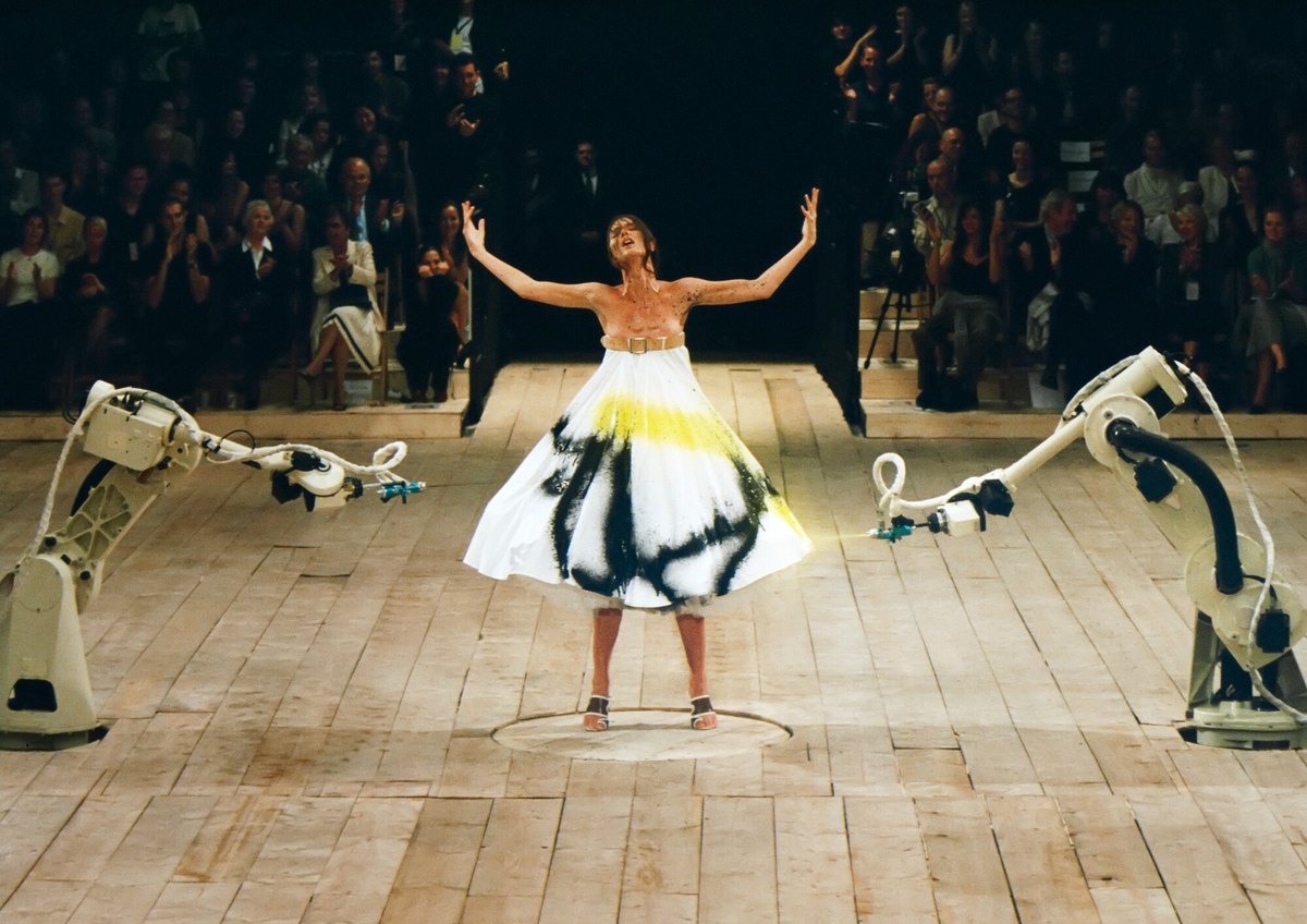 In one of the most memorable catwalk moments from Alexander McQueen's career, two robots spray-painted a dress worn by the model Shalom Harlow.