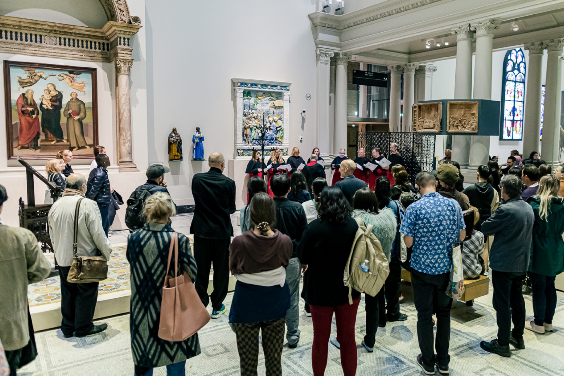 A tour group examines a sculpture at V&A South Kensington